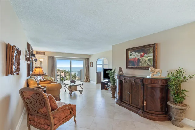 a living room with furniture a window and a flat screen tv