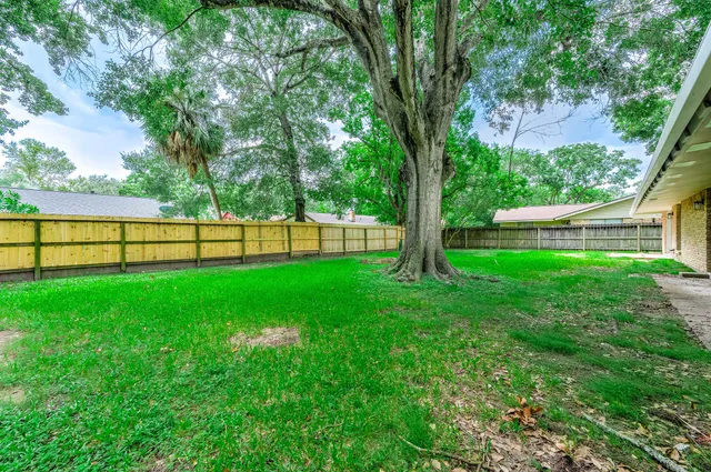 a view of backyard with a patio