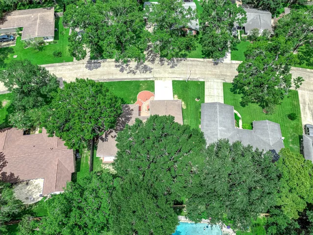 an aerial view of residential houses with outdoor space and river