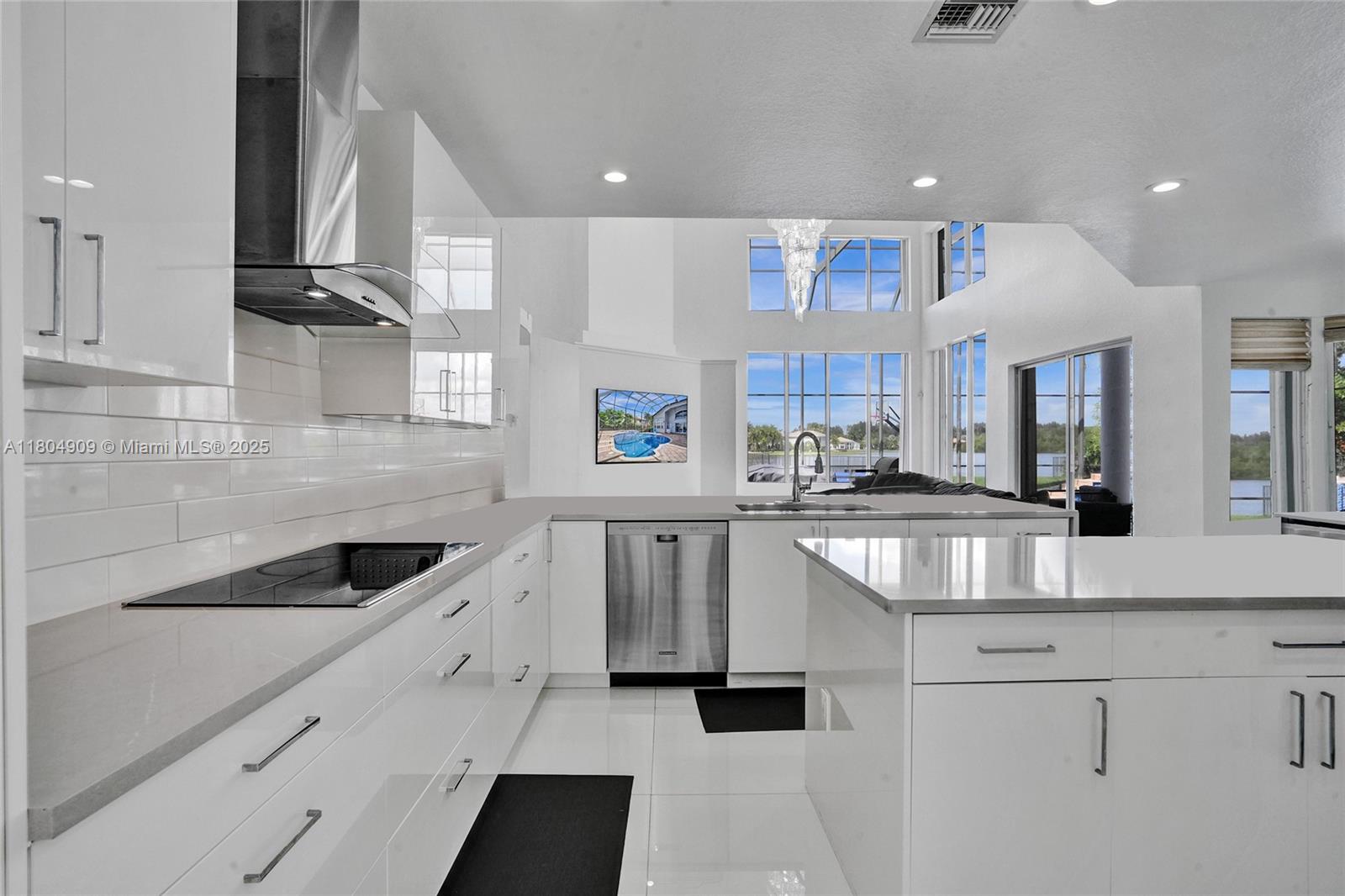 10457 Laurel Road Davie, FL 33328 - Photo 12 of 96 a kitchen with white cabinets and sink