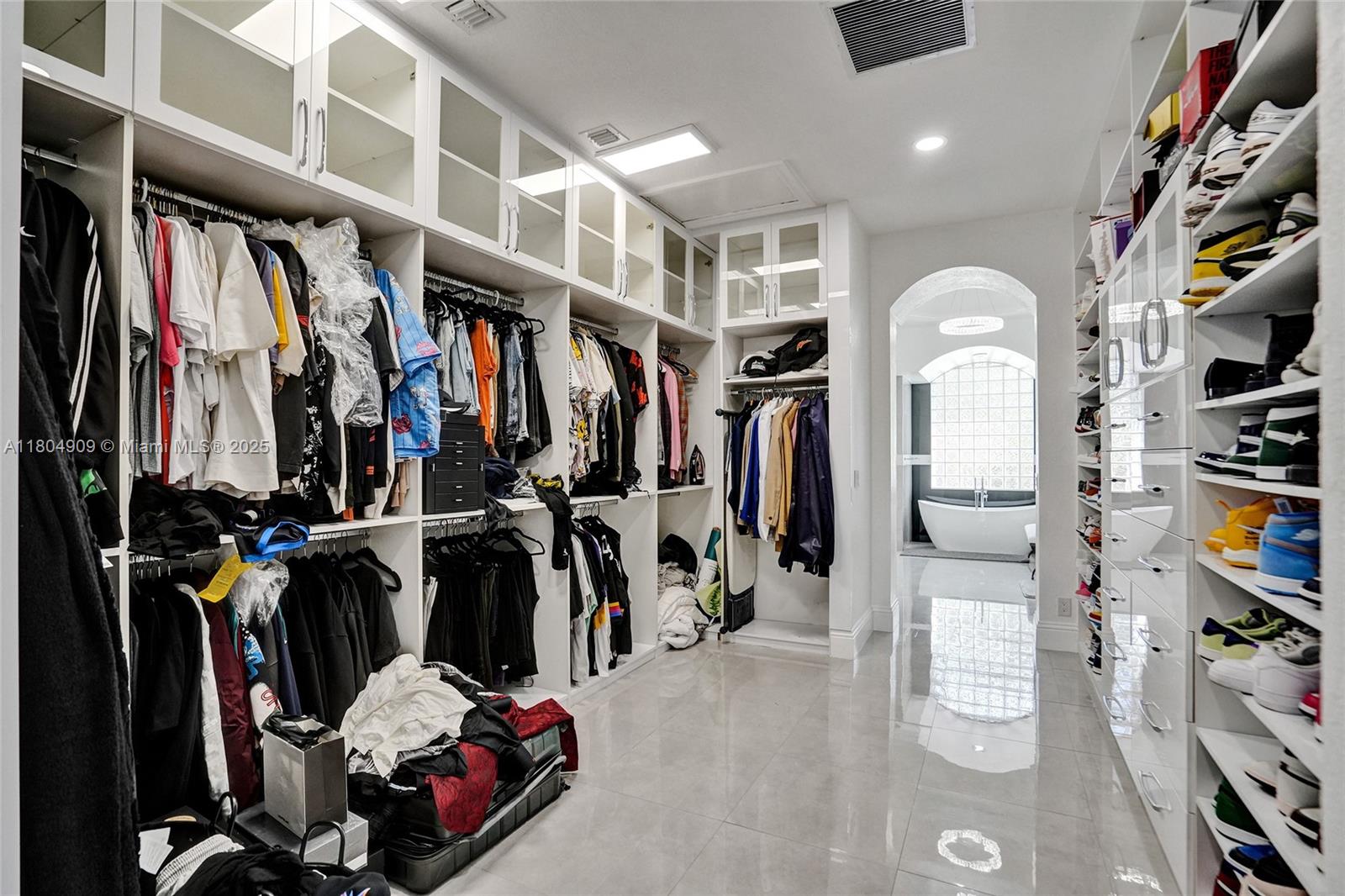 10457 Laurel Road Davie, FL 33328 - Photo 27 of 96 a view of walk in closet with clothes and shoes