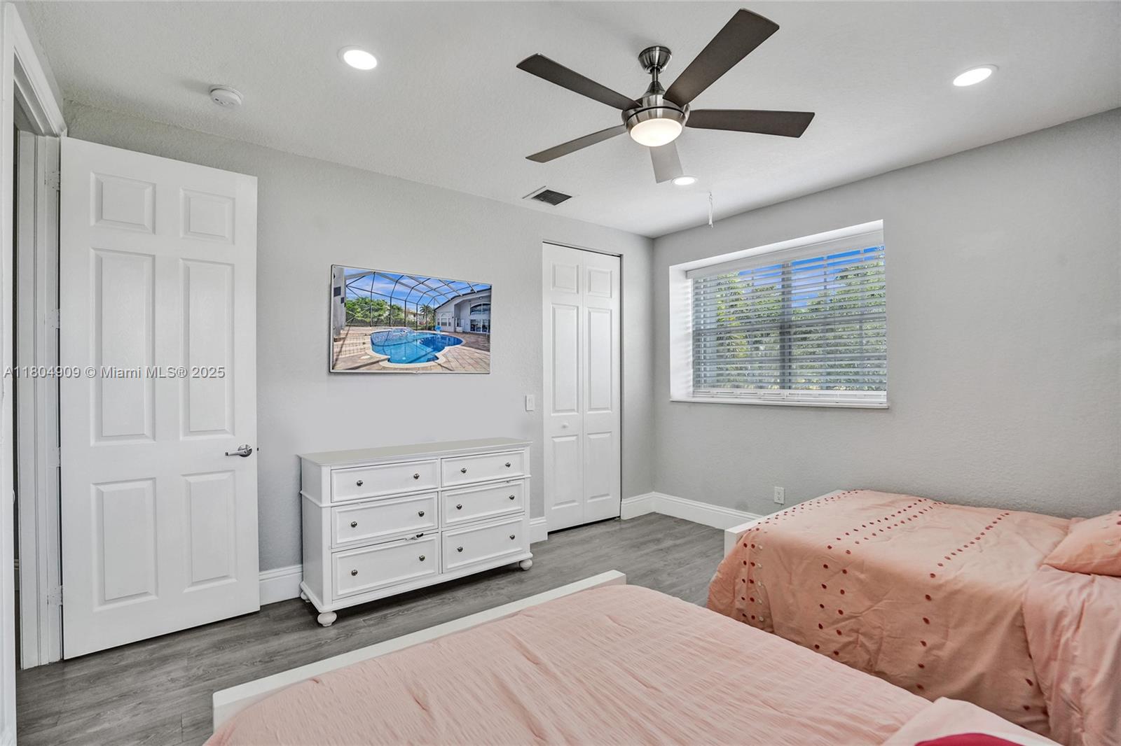10457 Laurel Road Davie, FL 33328 - Photo 49 of 96 a bedroom with a bed and a ceiling fan