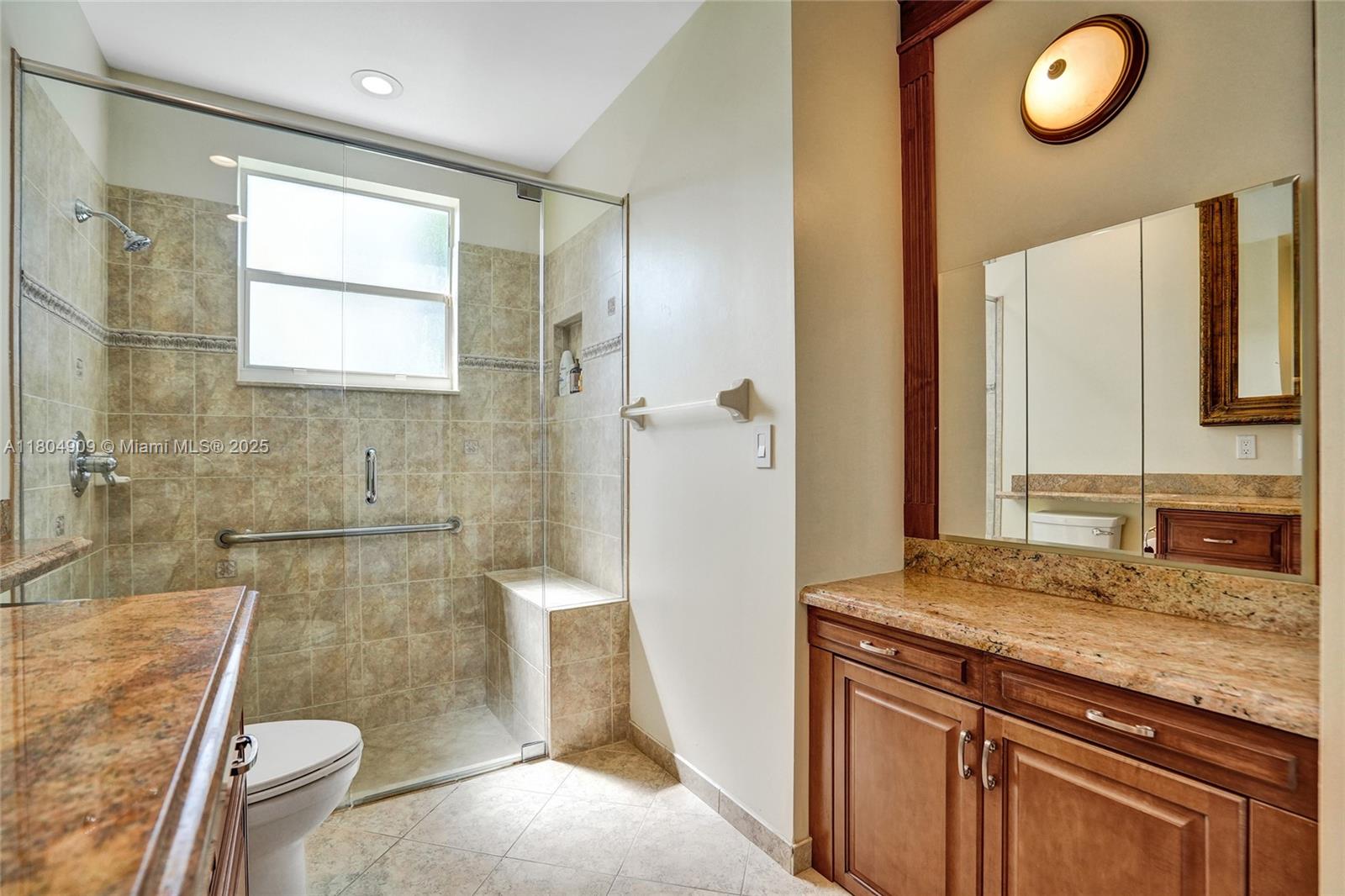10457 Laurel Road Davie, FL 33328 - Photo 61 of 96 a bathroom with a granite countertop sink a mirror and a bathtub