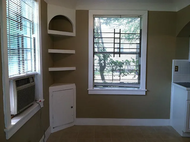 a view of an empty room with a kitchen