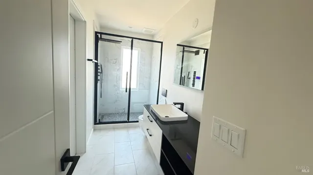 a bathroom with a sink a toilet and a mirror