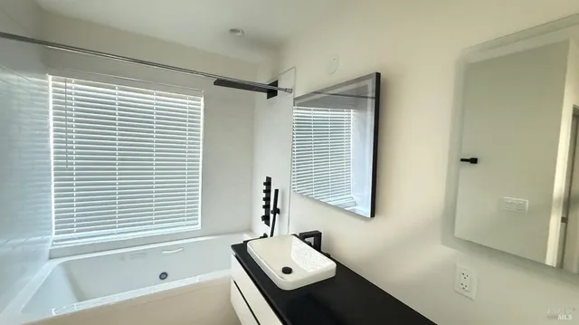 a bathroom with a bathtub and a window