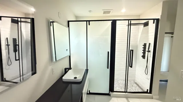a view of a bathroom with a tub and shower