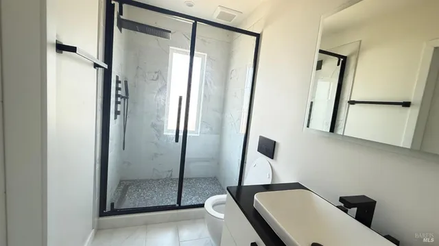 a bathroom with a toilet and a shower
