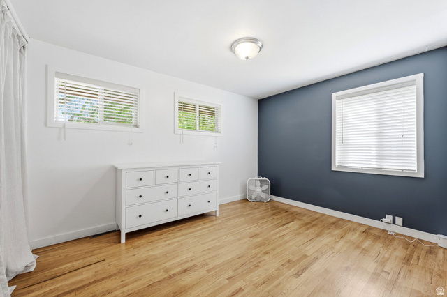 1709 Meadowmoor Road Holladay, UT 84117 - Photo 20 of 32 Hardwood-style flooring, white walls, and a single accent wall in a dark tone