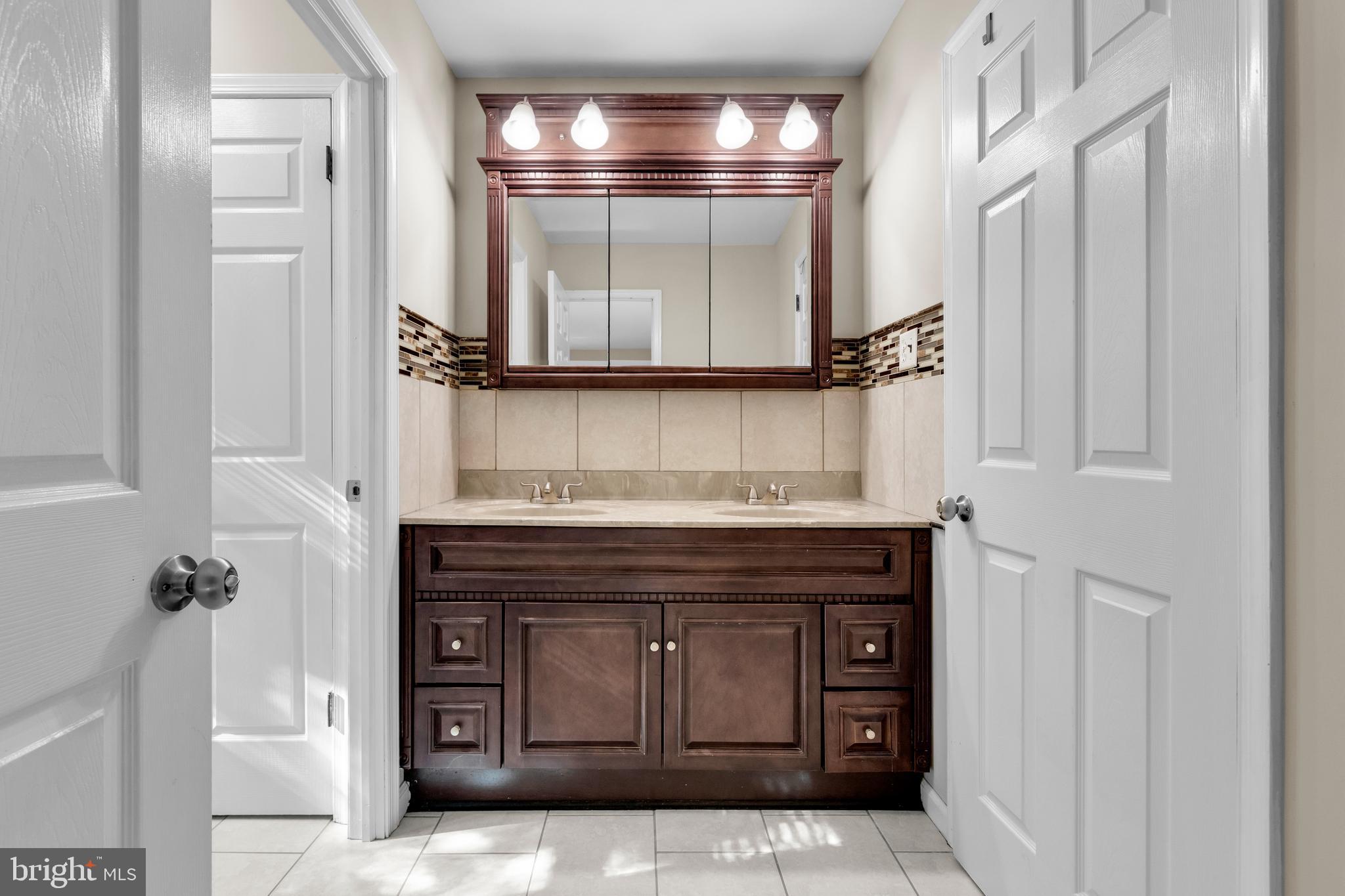 2773 Anvil Place Doylestown, PA 18902 - Photo 18 of 36 a bathroom with a sink and a mirror