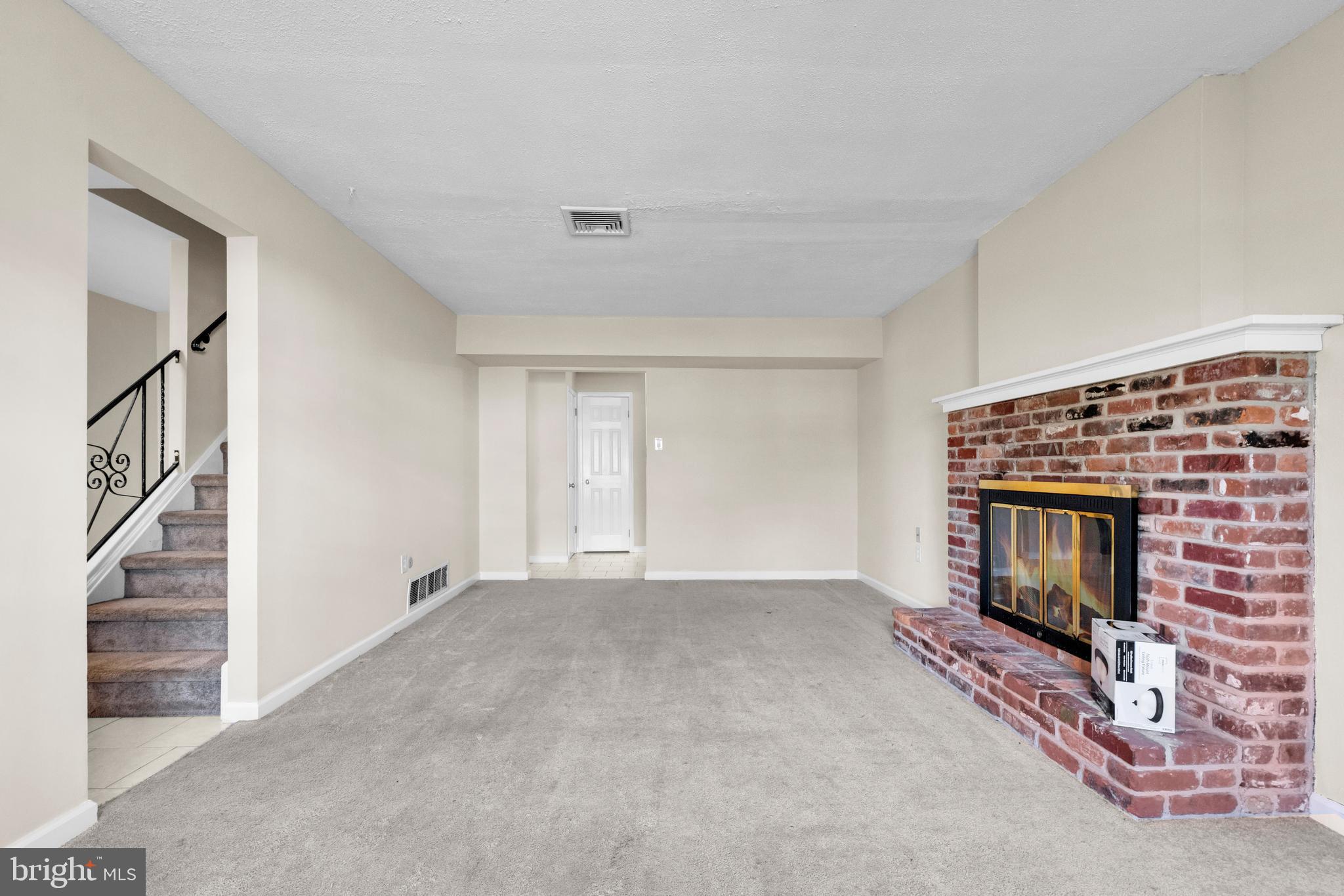2773 Anvil Place Doylestown, PA 18902 - Photo 4 of 36 a view of empty room with fireplace and stairs