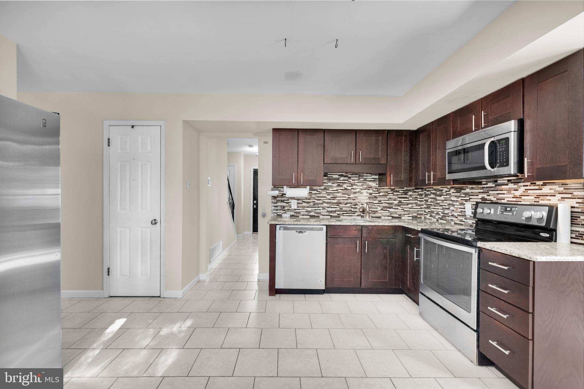 2773 Anvil Place Doylestown, PA 18902 - Photo 10 of 36 a kitchen with stainless steel appliances granite countertop a refrigerator and a stove top oven