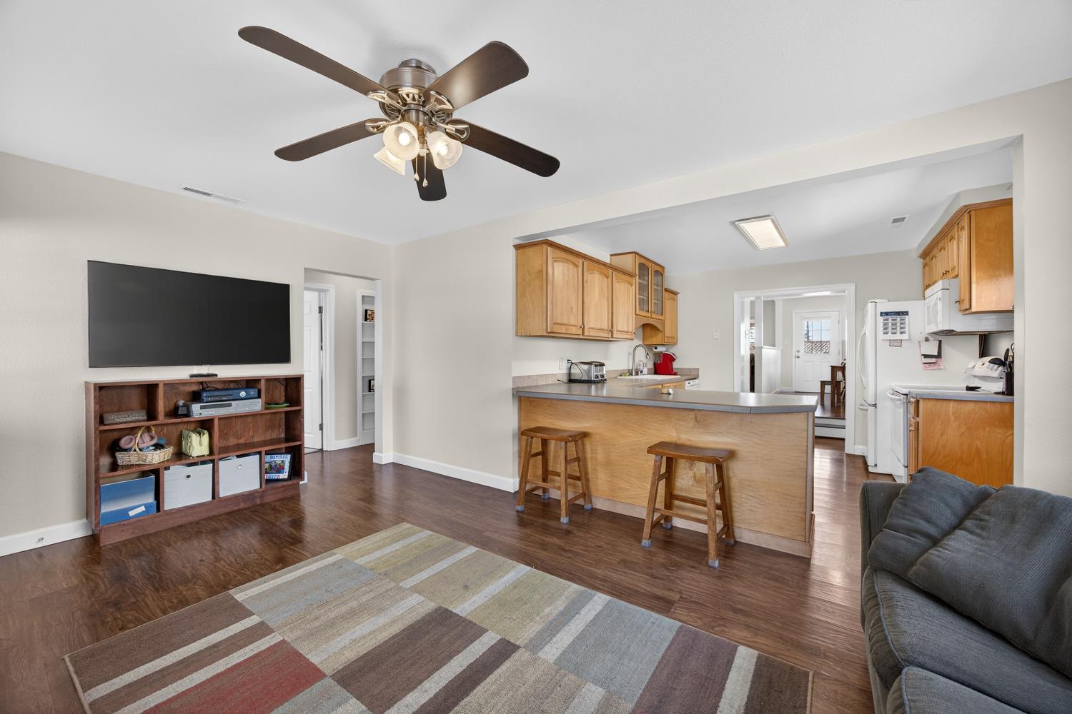 145 Oak Ridge Drive Ione, CA 95640 - Photo 28 of 61 a living room with furniture and a flat screen tv with kitchen view