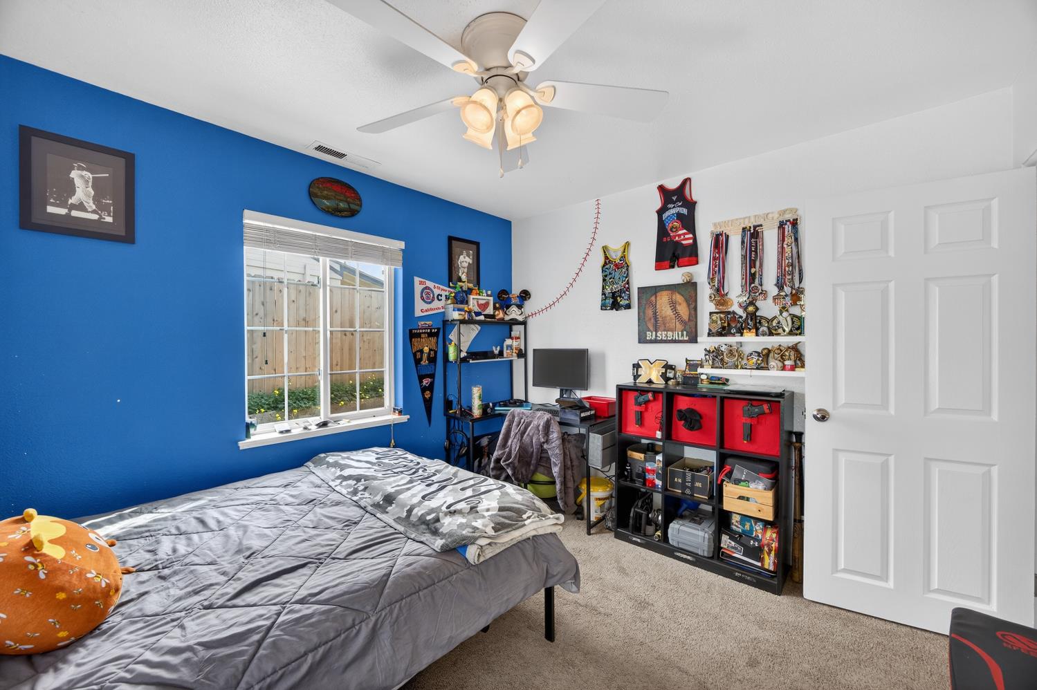 145 Oak Ridge Drive Ione, CA 95640 - Photo 44 of 61 a view of a bedroom with a bed and a chandelier