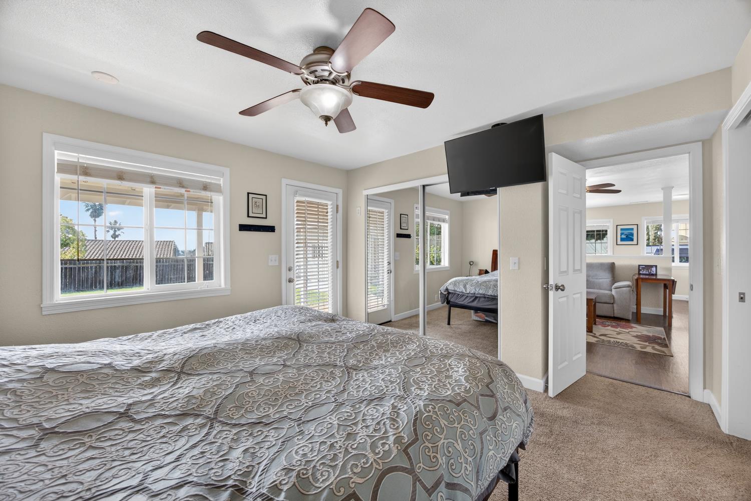 145 Oak Ridge Drive Ione, CA 95640 - Photo 48 of 61 a bedroom with a bed flat screen tv and a large window