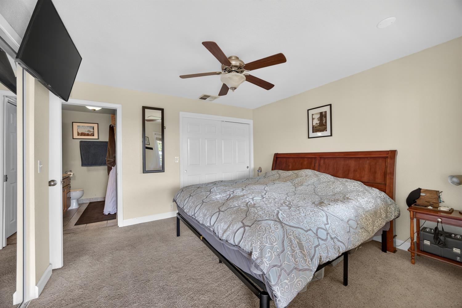 145 Oak Ridge Drive Ione, CA 95640 - Photo 49 of 61 a bedroom with a bed and a chandelier