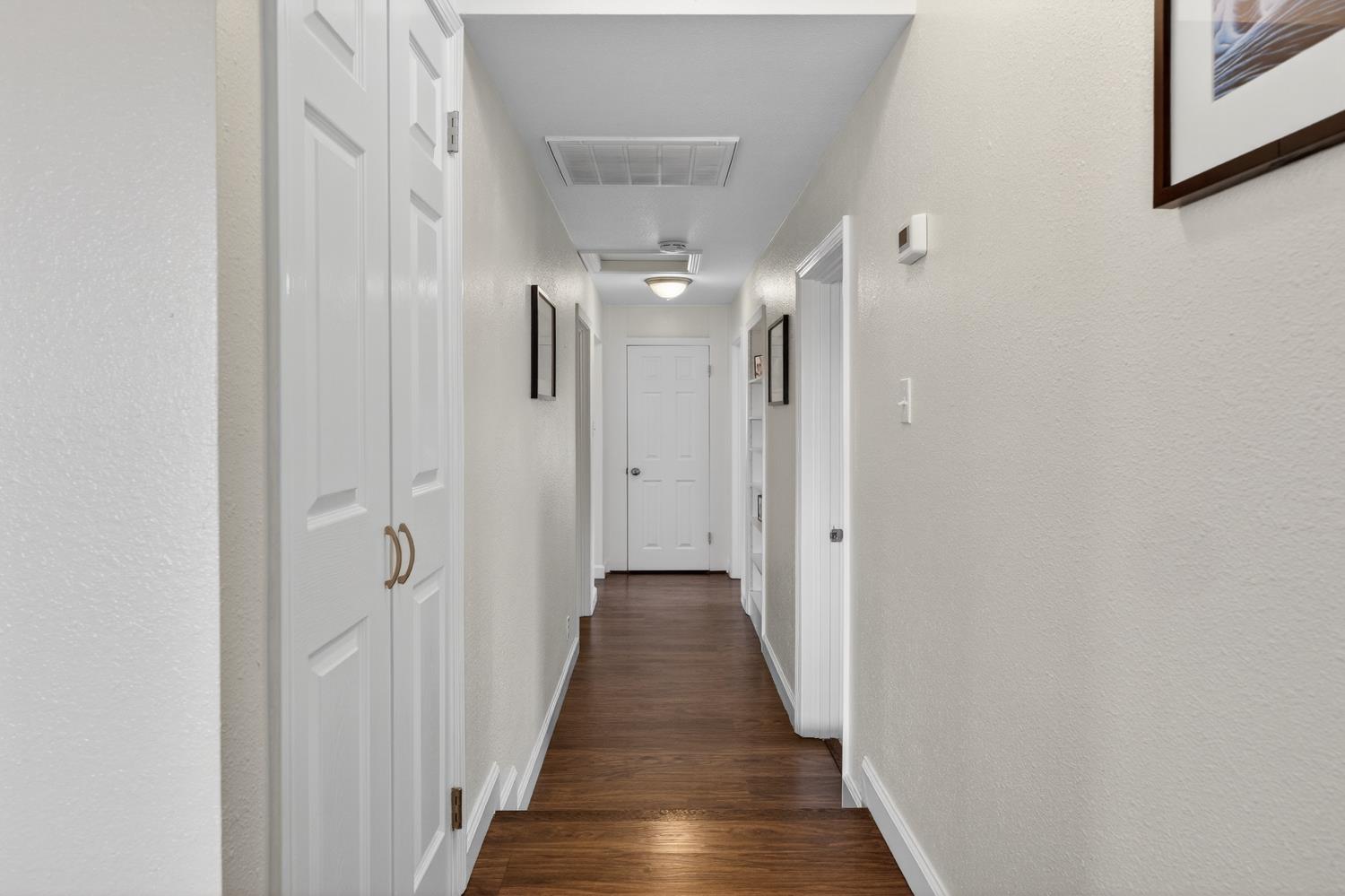 145 Oak Ridge Drive Ione, CA 95640 - Photo 53 of 61 a view of a hallway with wooden floor and closet