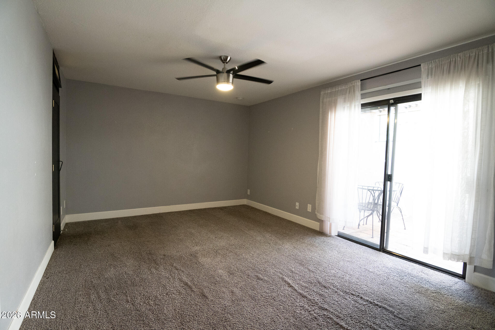 5100 North Miller Road, Unit 3 Scottsdale, AZ 85250 - Photo 22 of 31 an empty room with a window and ceiling fan