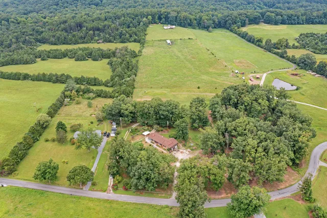 an aerial view of residential houses with outdoor space and swimming pool