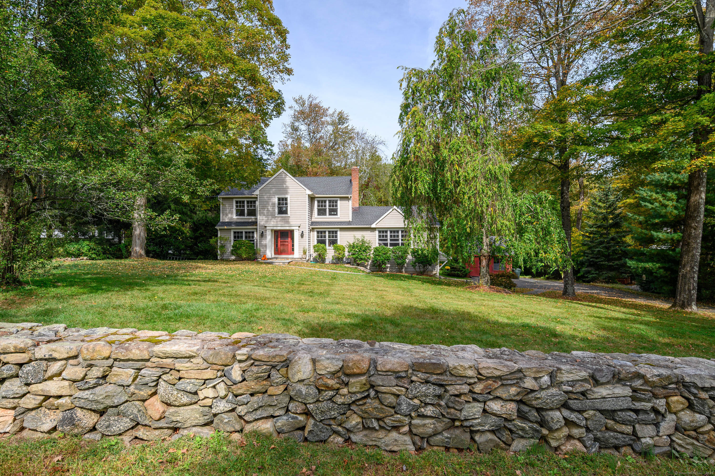 16 Rock Ridge Road Newtown, CT 06470 - Photo 1 of 1 Front of house with beautiful rock wall