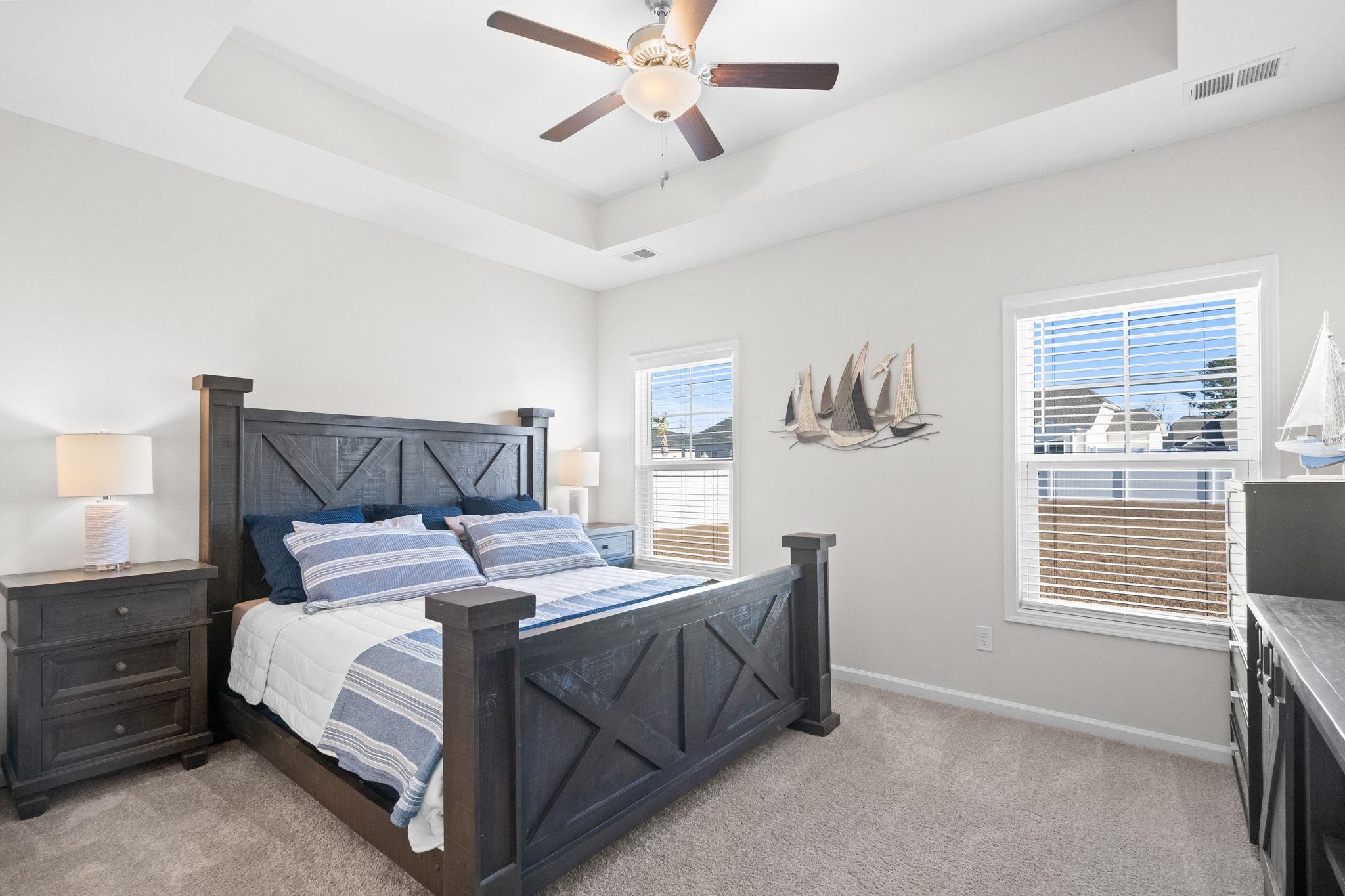447 Honeyhill Loop Conway, SC 29526 - Photo 17 of 39 Bedroom featuring a tray ceiling, light carpet, and ceiling fan