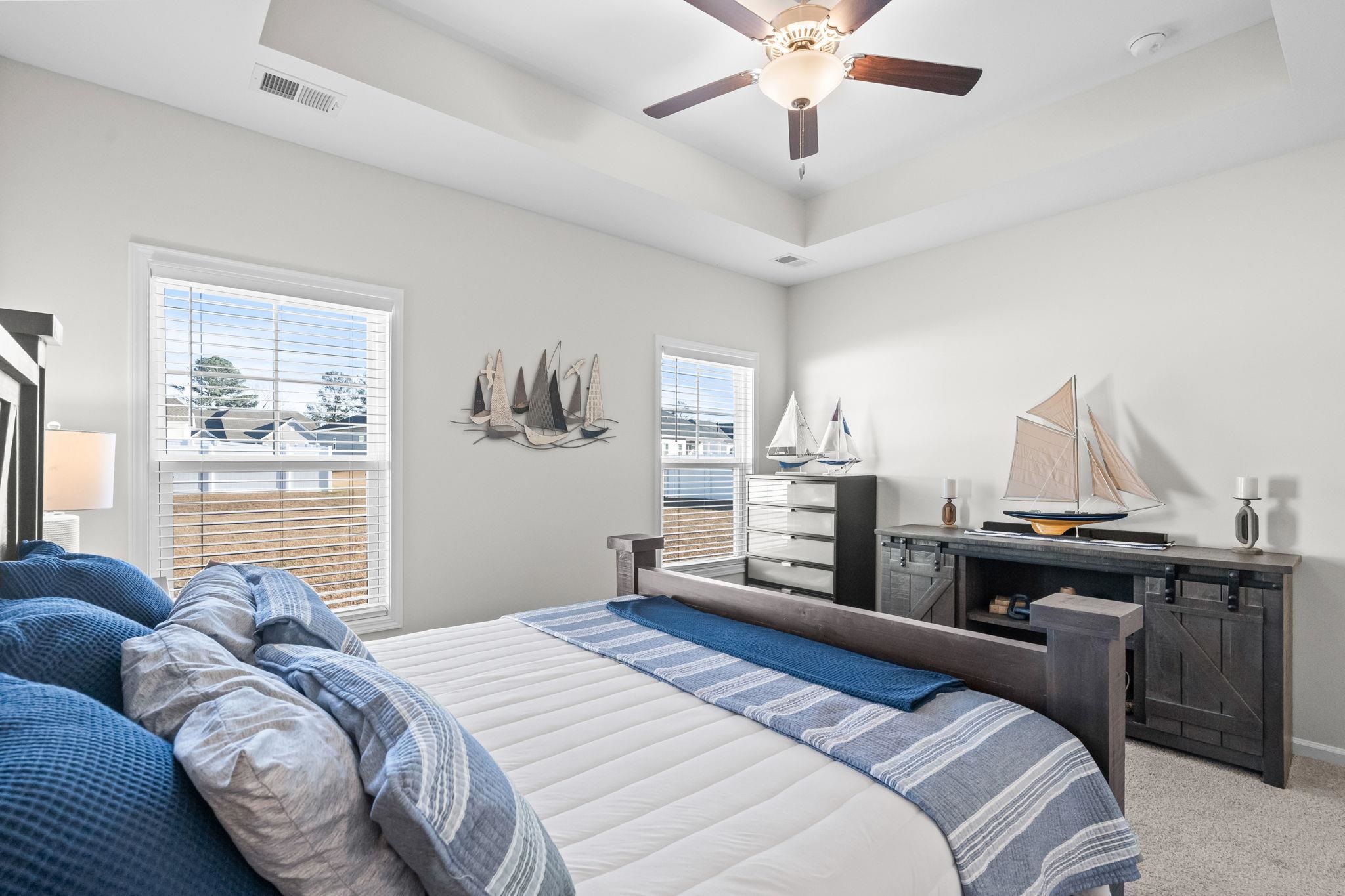 447 Honeyhill Loop Conway, SC 29526 - Photo 18 of 39 Bedroom with a tray ceiling, light carpet, and a ceiling fan