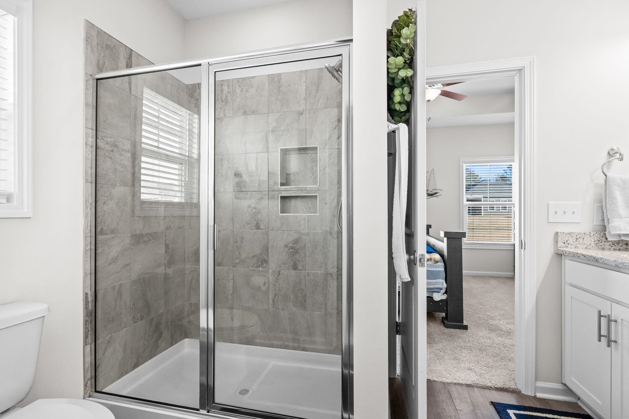 447 Honeyhill Loop Conway, SC 29526 - Photo 20 of 39 Ensuite bathroom with vanity, a shower stall, dark wood-style flooring, and ceiling fan