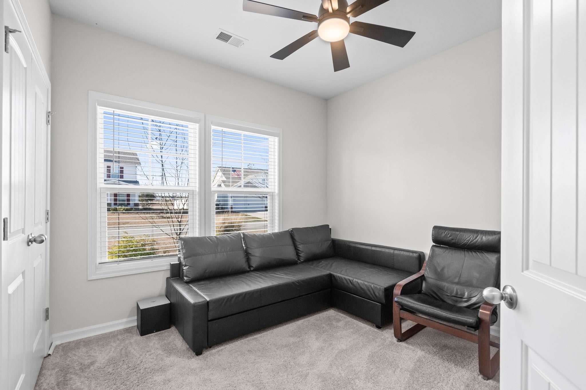 447 Honeyhill Loop Conway, SC 29526 - Photo 23 of 39 Living area featuring light colored carpet and ceiling fan