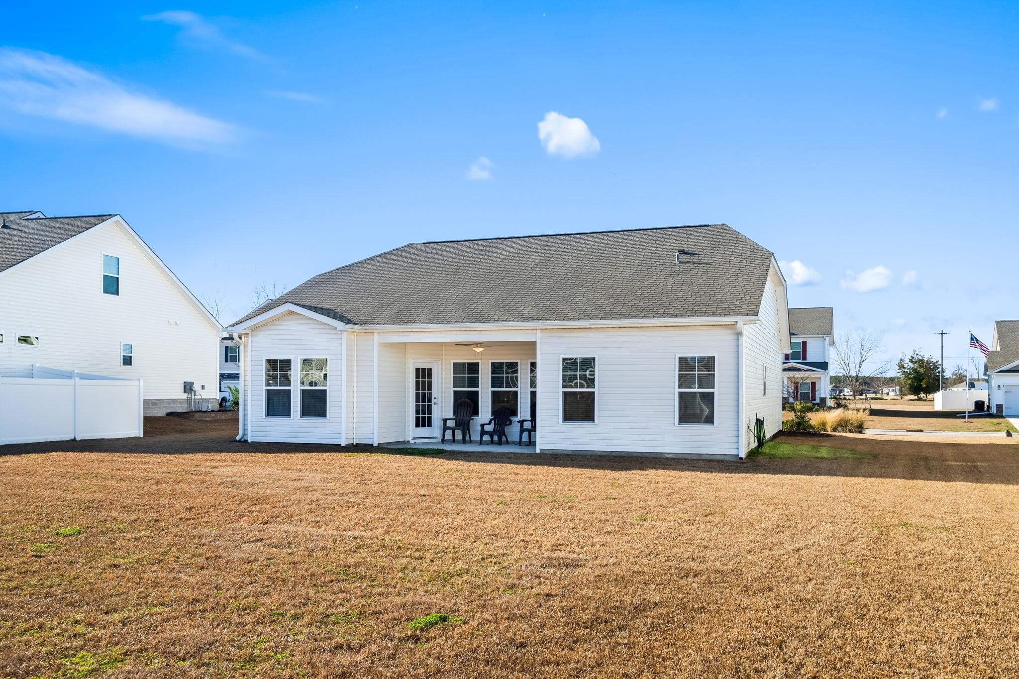 447 Honeyhill Loop Conway, SC 29526 - Photo 29 of 39 Rear view of house featuring a patio area, a ceiling fan, and roof with shingles
