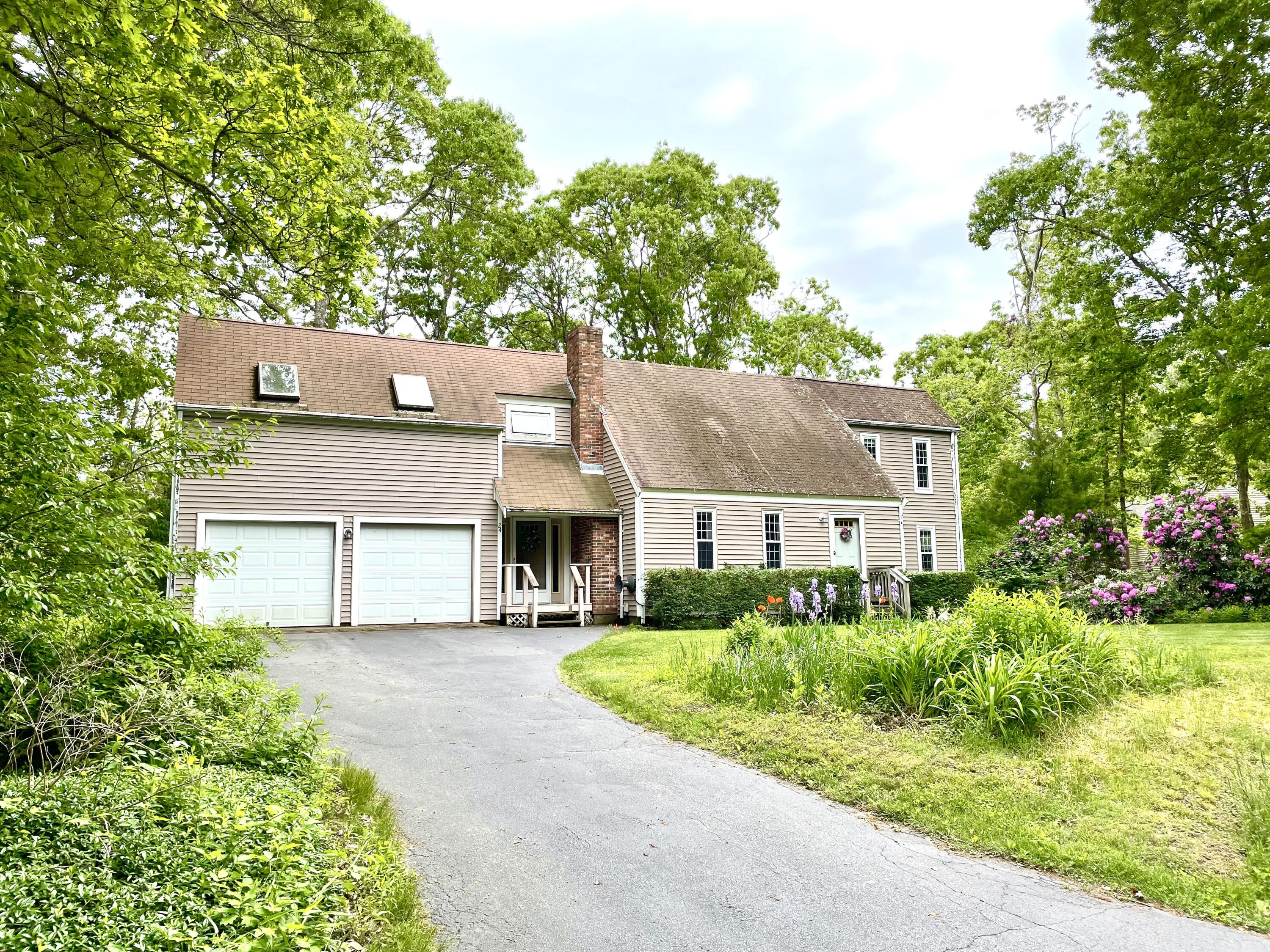 24 Fawn Road Mashpee, MA 02649 - Photo 1 of 23 front view of a house with a garden