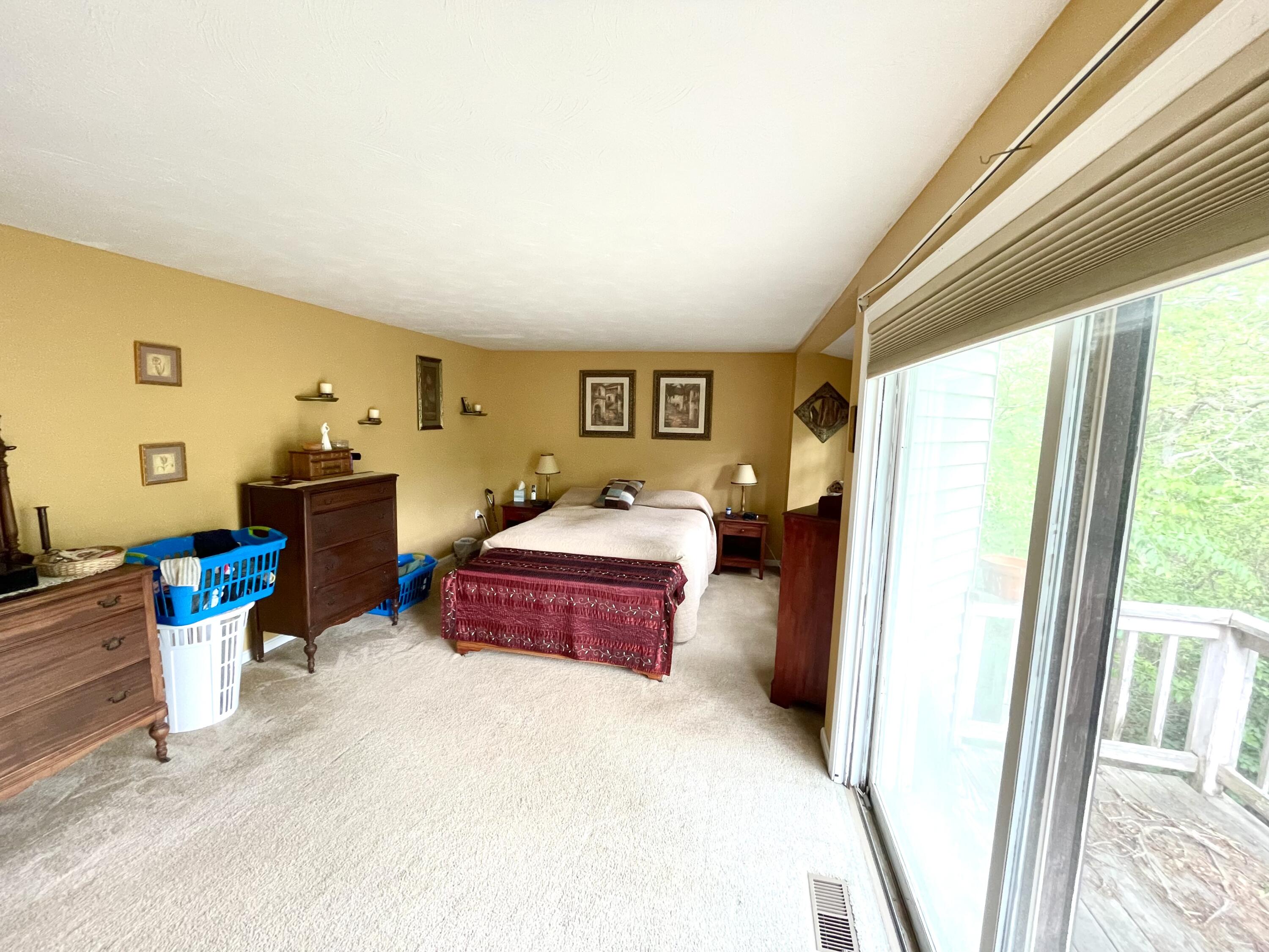 24 Fawn Road Mashpee, MA 02649 - Photo 14 of 23 a spacious bedroom with a bed and wooden floor