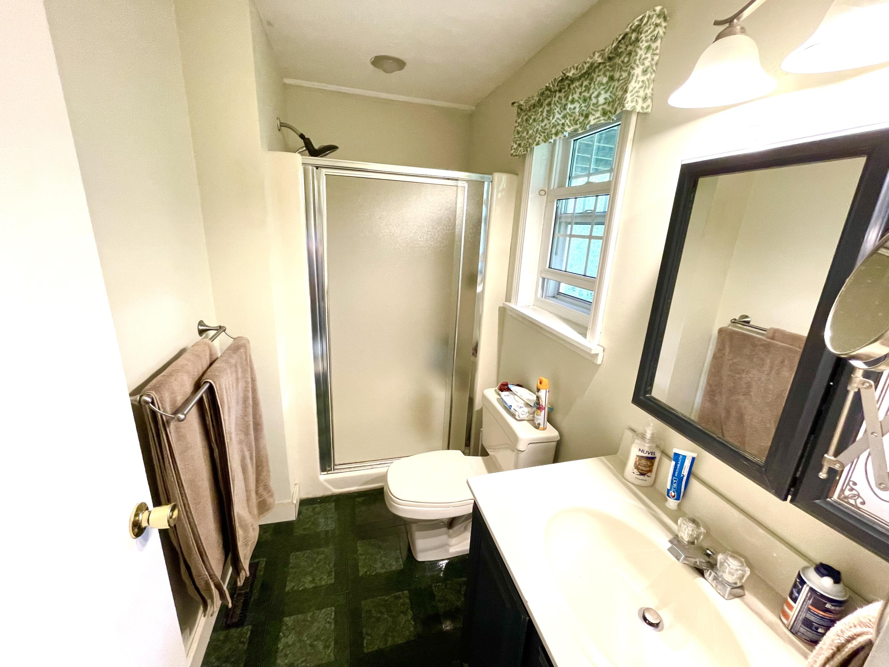 24 Fawn Road Mashpee, MA 02649 - Photo 23 of 23 a bathroom with a sink a mirror and a toilet