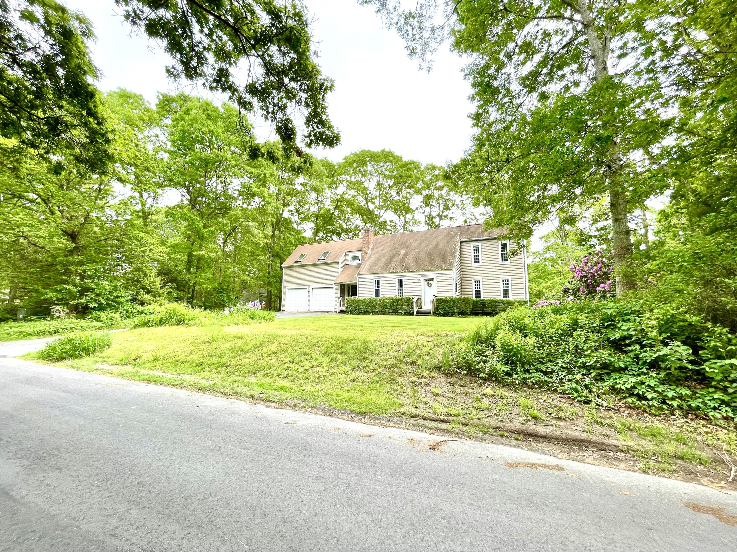24 Fawn Road Mashpee, MA 02649 - Photo 3 of 23 a house with trees in front of it