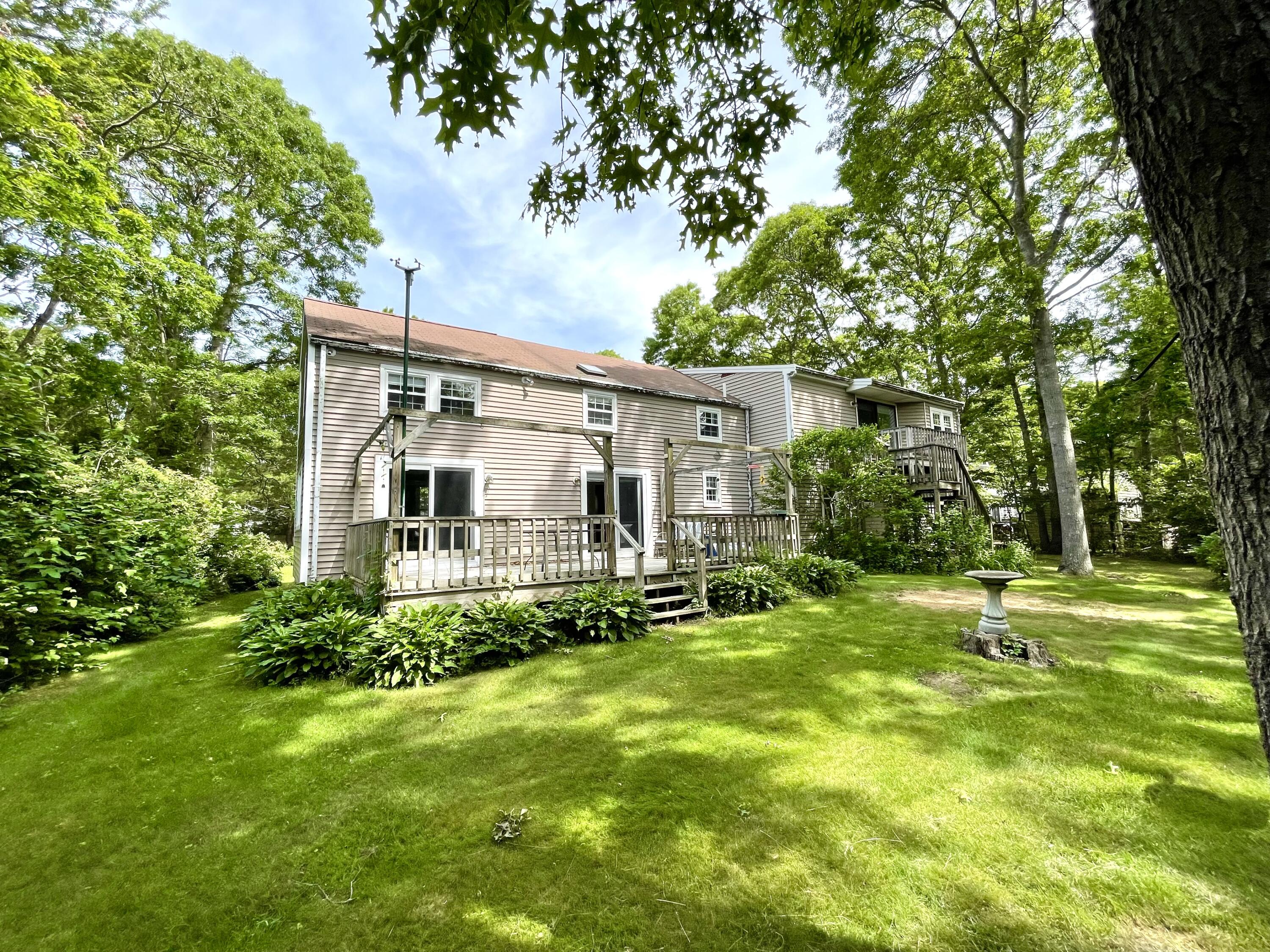 24 Fawn Road Mashpee, MA 02649 - Photo 4 of 23 a view of a house with backyard and sitting area