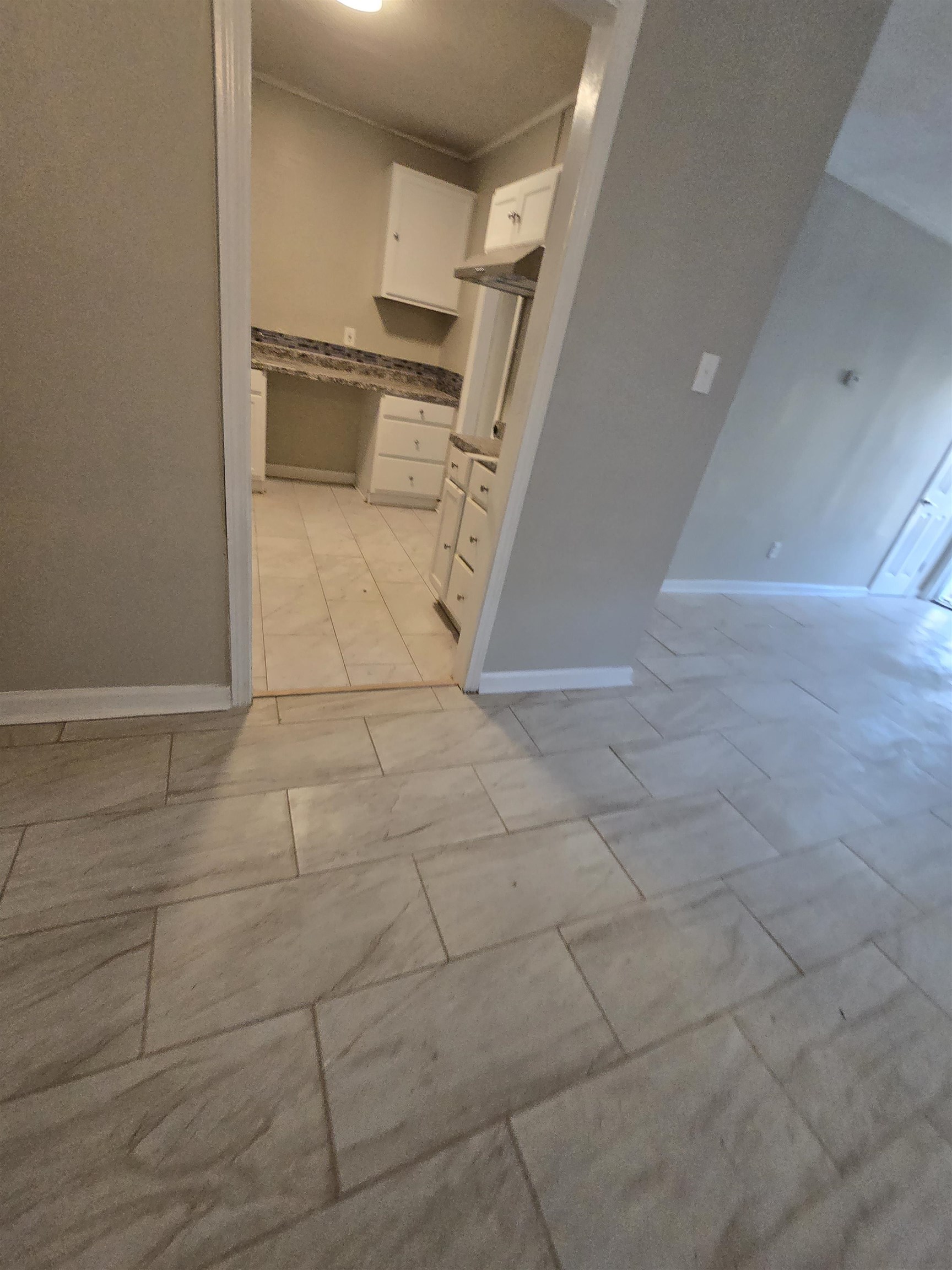 3198 Millwood Road Memphis, TN 38109 - Photo 3 of 5 Kitchen with white cabinetry and baseboards