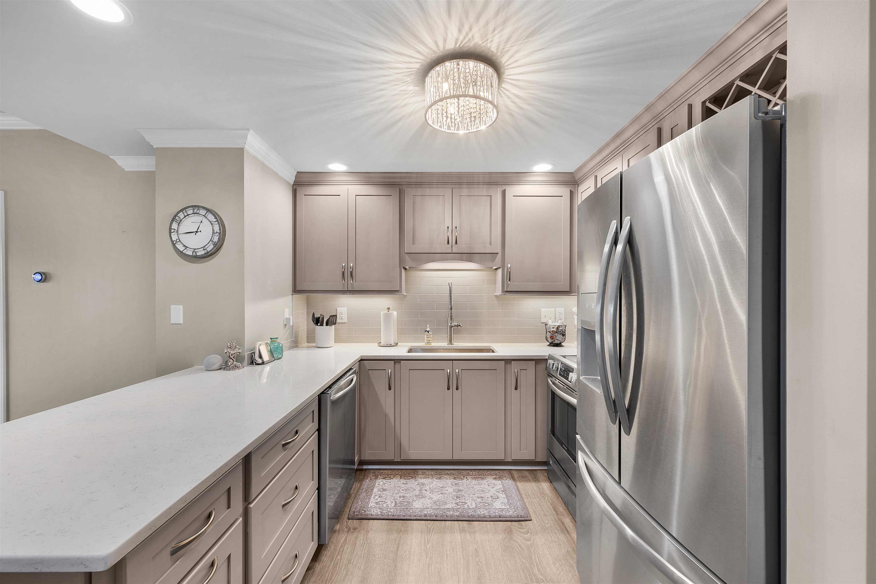 323 Cr 380 Road, Unit P 506 Iuka, MS 38852 - Photo 7 of 21 Kitchen with stainless steel appliances, a peninsula, ornamental molding, light wood finished floors, and recessed lighting