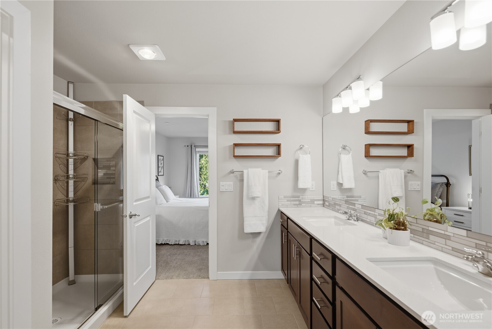 1621 Seattle Hill Road, Unit J5 Bothell, WA 98012 - Photo 30 of 40 a spacious bathroom with a double vanity sink a large mirror a shower and vanity
