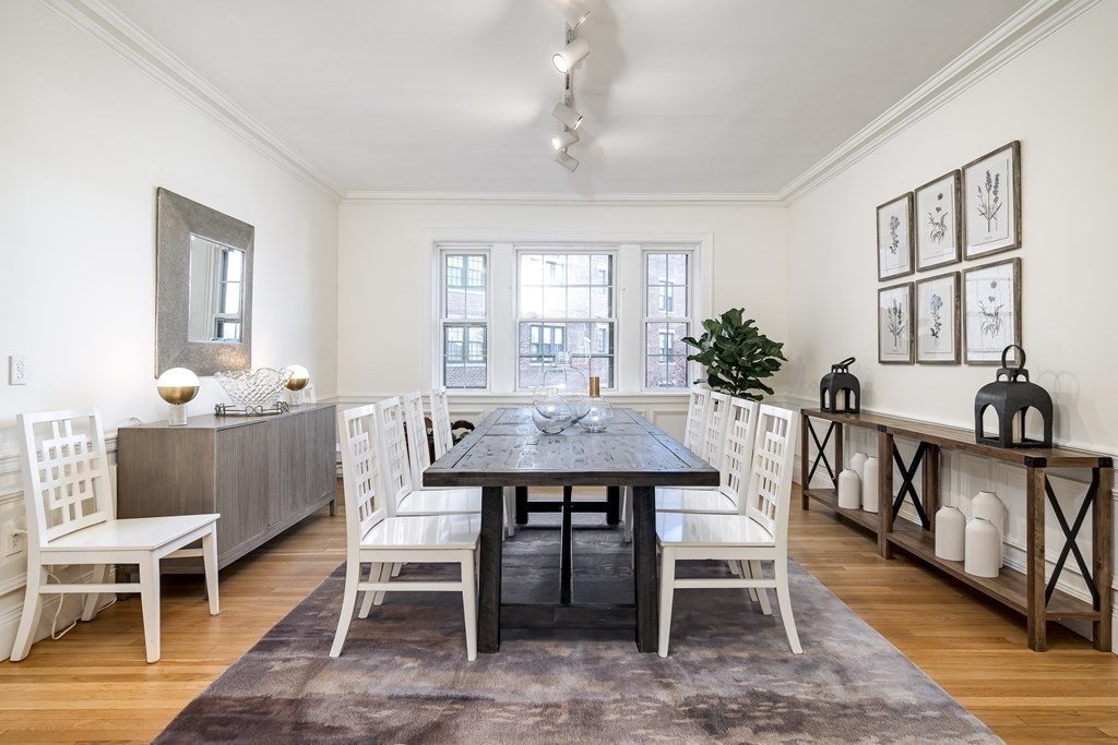 986 Memorial Drive, Unit 404 Cambridge, MA 02138 - Photo 11 of 41 a dining room with furniture window and wooden floor