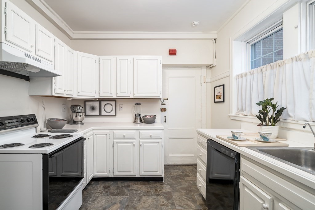 986 Memorial Drive, Unit 404 Cambridge, MA 02138 - Photo 16 of 41 a kitchen with a sink cabinets and white appliances