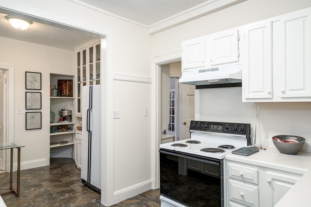 986 Memorial Drive, Unit 404 Cambridge, MA 02138 - Photo 17 of 41 a kitchen with stainless steel appliances granite countertop a stove and a refrigerator