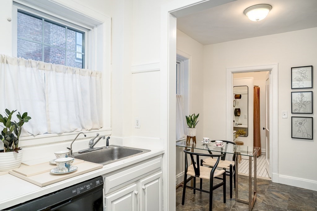 986 Memorial Drive, Unit 404 Cambridge, MA 02138 - Photo 18 of 41 a view of a kitchen area with furniture and wooden floor