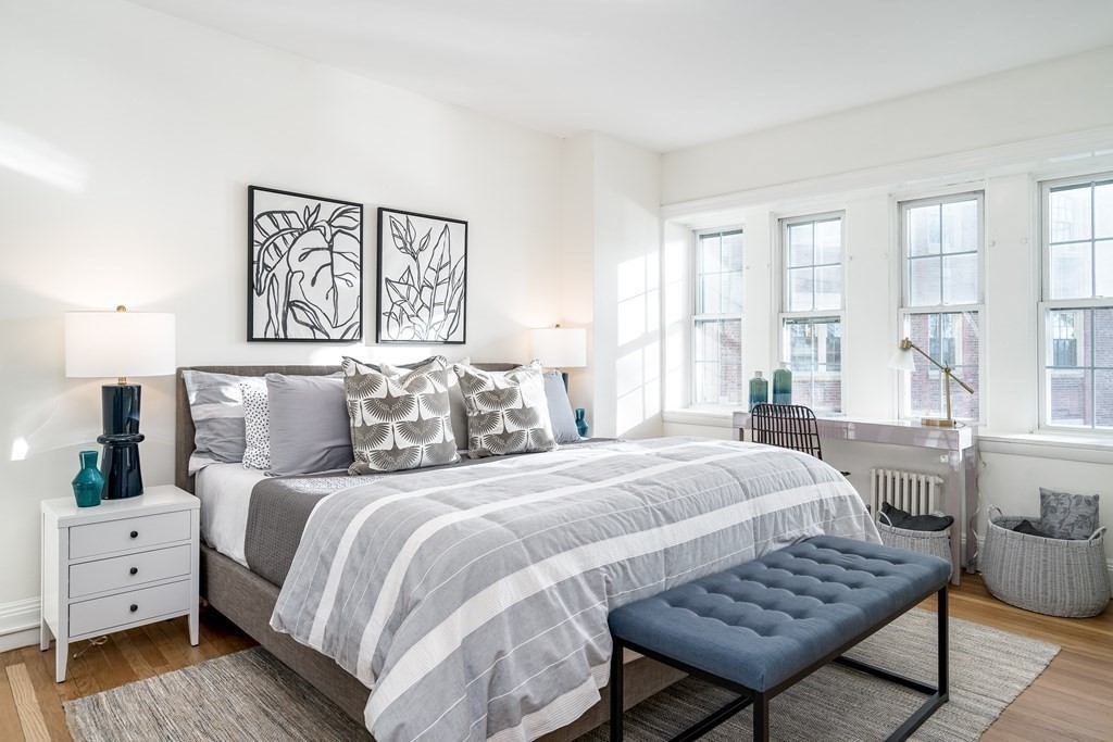 986 Memorial Drive, Unit 404 Cambridge, MA 02138 - Photo 22 of 41 a bedroom with a bed and wooden floor