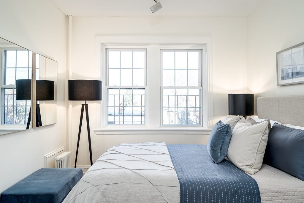 986 Memorial Drive, Unit 404 Cambridge, MA 02138 - Photo 28 of 41 a bedroom with a bed tv and a window