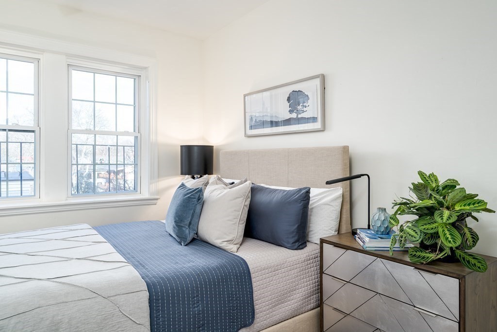986 Memorial Drive, Unit 404 Cambridge, MA 02138 - Photo 29 of 41 a bedroom with a bed and a window