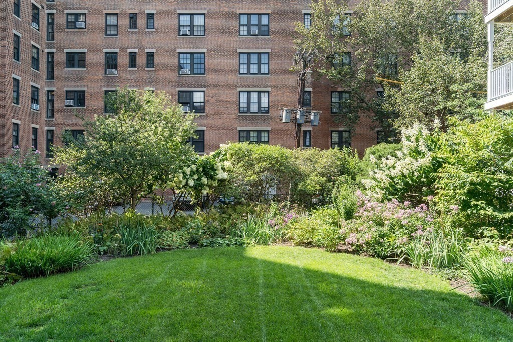 986 Memorial Drive, Unit 404 Cambridge, MA 02138 - Photo 38 of 41 a view of a brick building next to a big yard