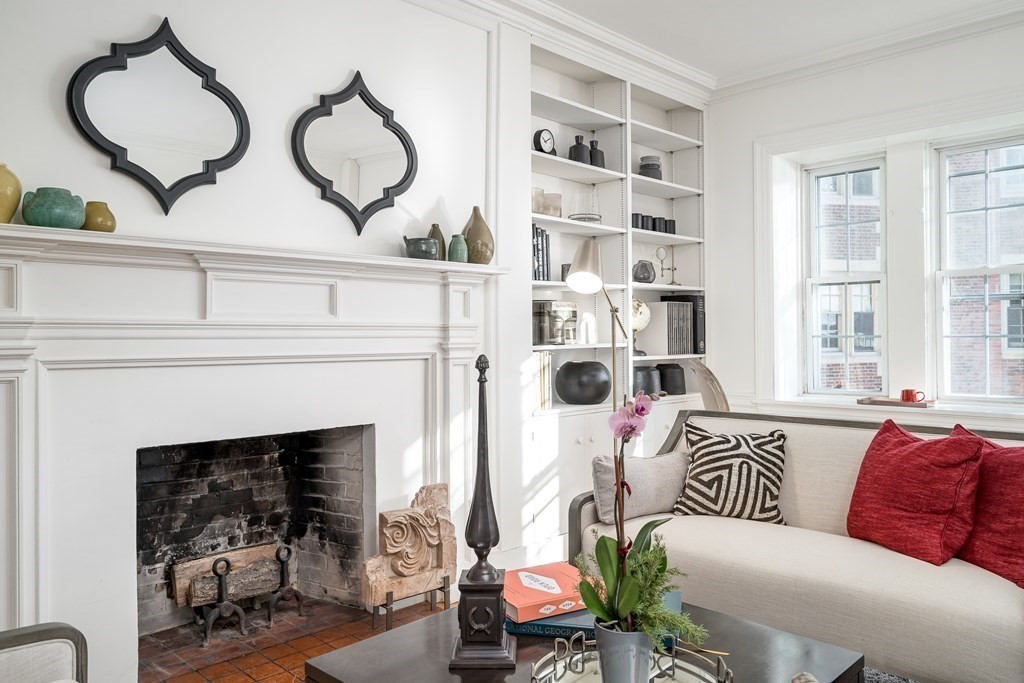 986 Memorial Drive, Unit 404 Cambridge, MA 02138 - Photo 6 of 41 a living room with furniture a fireplace and windows