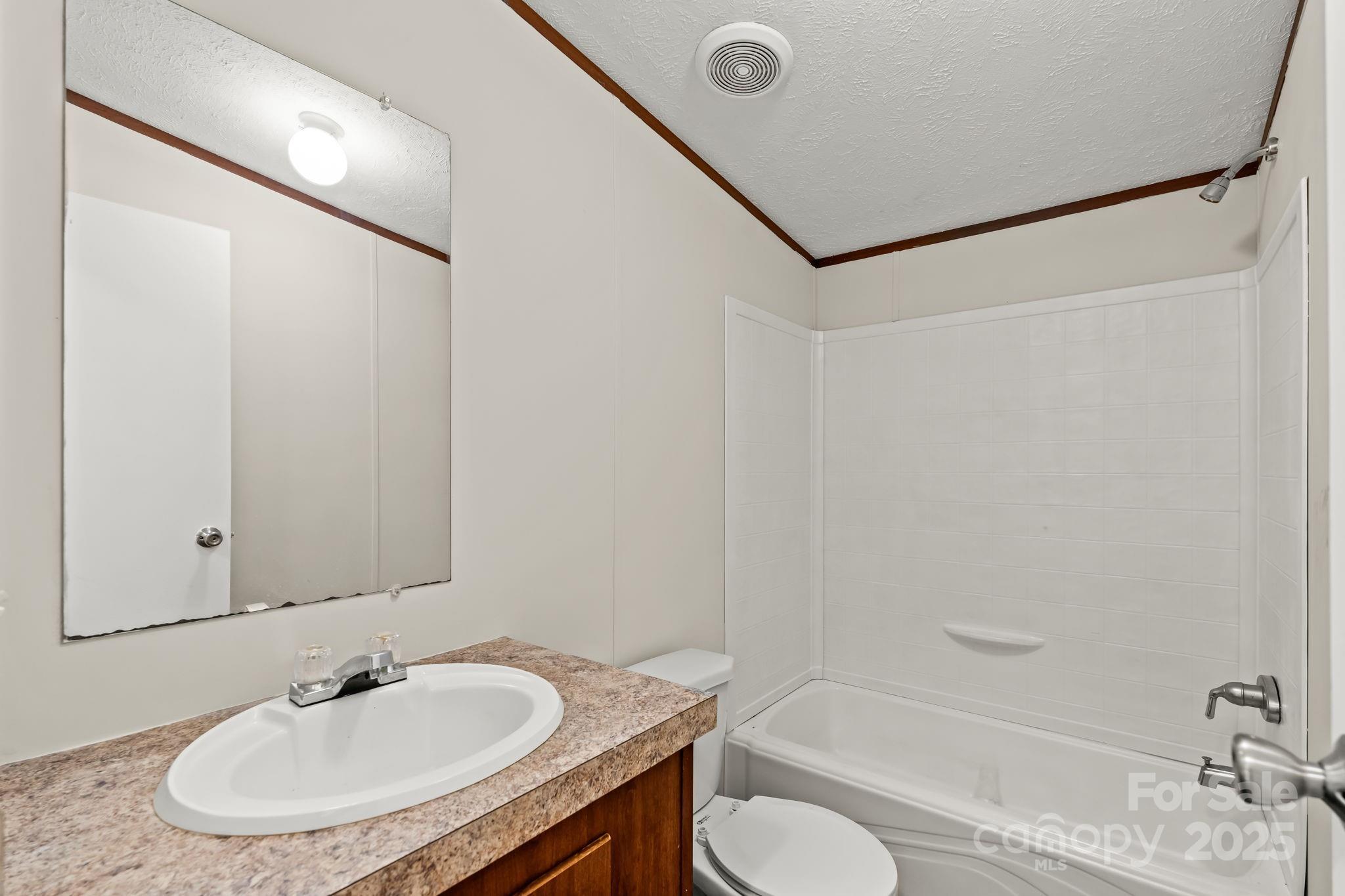 1080 Beckham Road Salisbury, NC 28147 - Photo 25 of 30 a bathroom with a granite countertop sink and a mirror