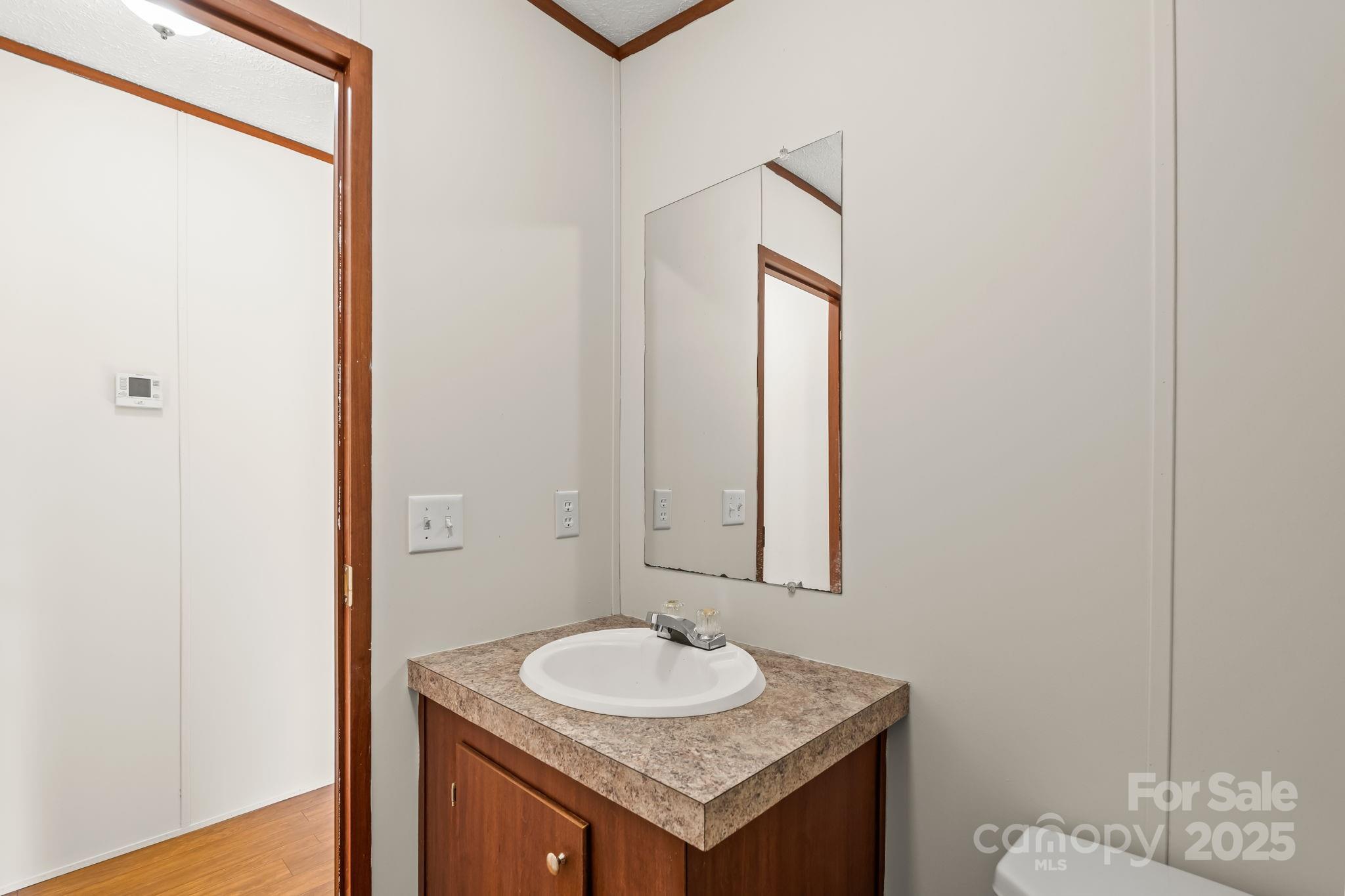 1080 Beckham Road Salisbury, NC 28147 - Photo 26 of 30 a bathroom with a sink and a mirror