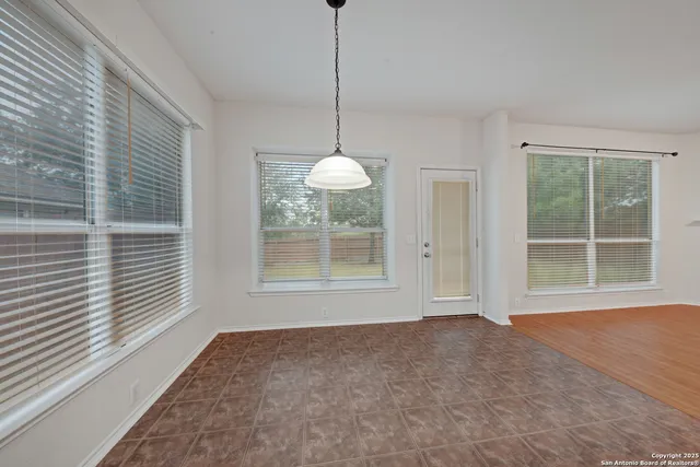 a kitchen that has a lot of cabinets in it and wooden floors