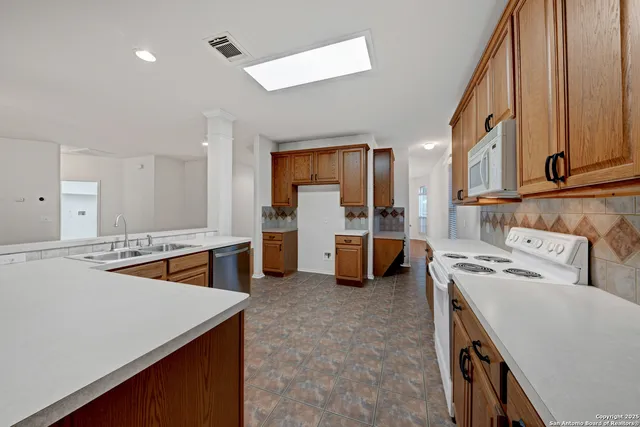 a kitchen with a sink a stove and cabinets